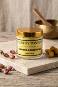 Earthy Tones 9 Turmeric & Rose Ubtan (facemask) on a marble slab with turmeric roots and rose petals.