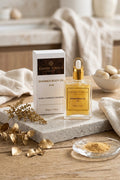 Earthy Tones 9 shimmer body oil 50ml bottle and packaging on a wooden surface with decorative elements.